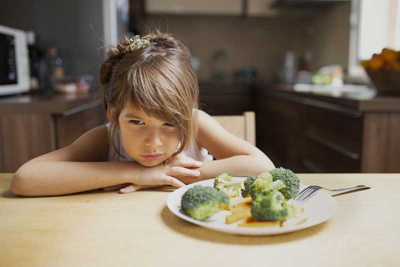front view picky girl refuse vegetables 800