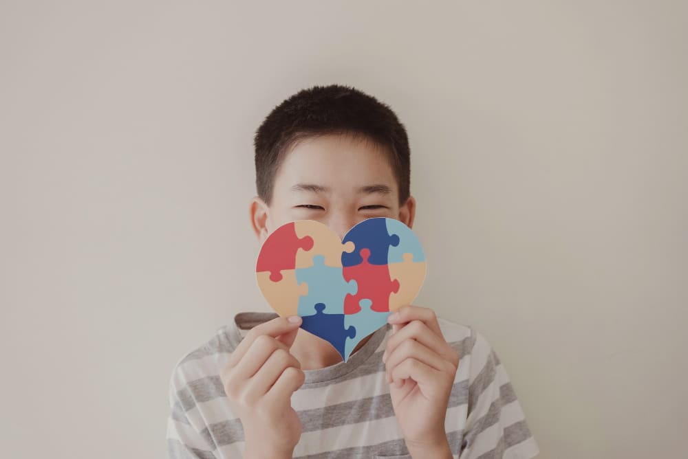 Boy holding jigsaw puzzle